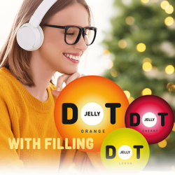 Woman in a orange sweater, glasses and headphones is smilling, in the background is christmas tree, in front of her is Jelly DOT with filling logo